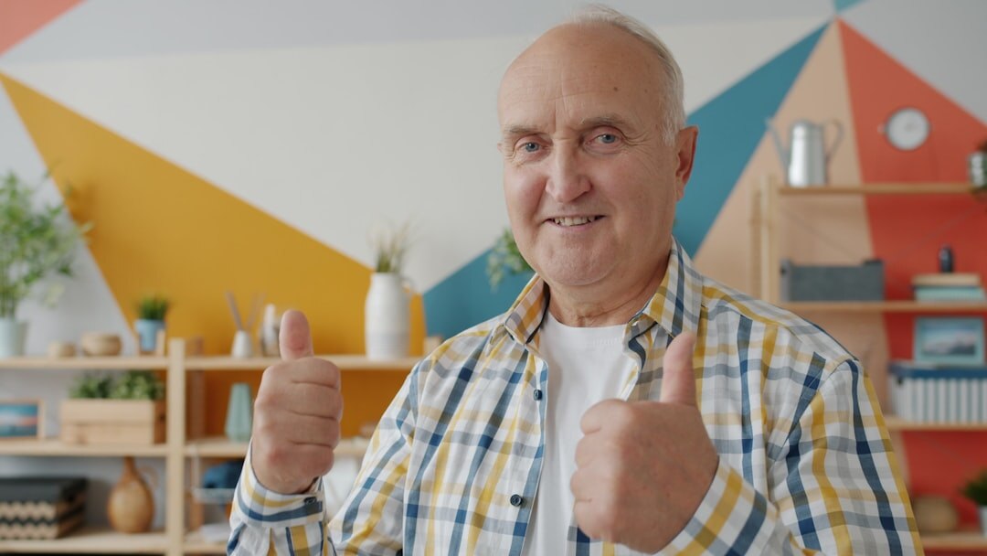 Portrait of a friendly senior man activities coordinator smiling